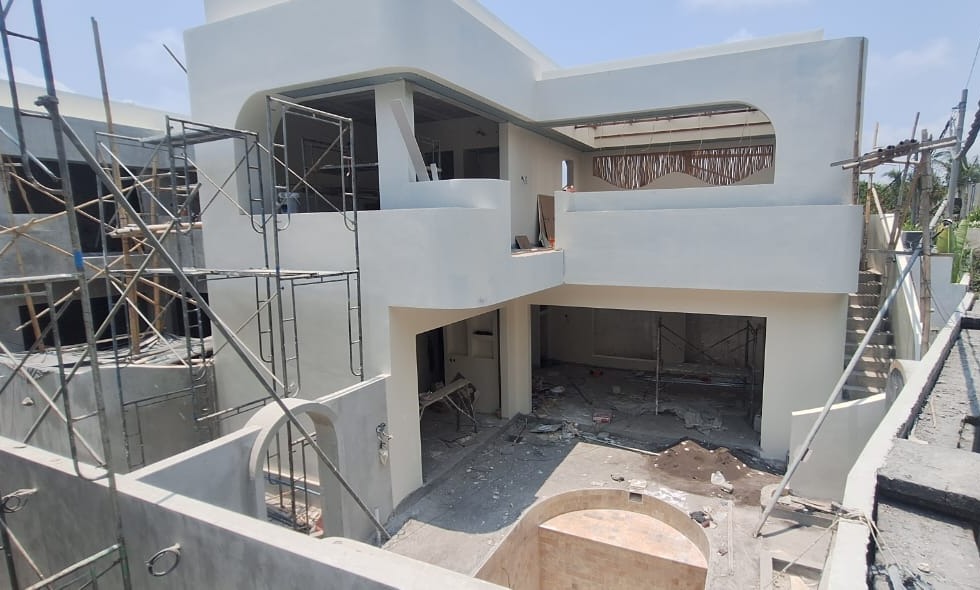 Villa with the exterior rendered, the pool tiled and scaffolding still up